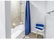Clean bathroom with shower/tub combo and blue shower curtain at 11339 Tayport Loop, New Port Richey, FL 34654
