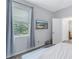 Bedroom with gray walls and a TV mounted on the wall at 11339 Tayport Loop, New Port Richey, FL 34654
