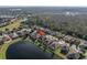 Aerial view of a house near a lake at 11339 Tayport Loop, New Port Richey, FL 34654