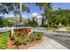 Community entrance with landscaping and building numbers at 820 Virginia St # 202, Dunedin, FL 34698