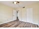 Bedroom with wood-look floors, ceiling fan and door to another room at 820 Virginia St # 202, Dunedin, FL 34698