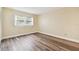 Bright bedroom with wood-look floors and neutral walls at 820 Virginia St # 202, Dunedin, FL 34698