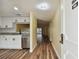 Kitchen and living area view from entryway with wood floors at 820 Virginia St # 202, Dunedin, FL 34698