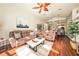 Bright living room featuring hardwood floors, comfy seating, and an open floor plan at 5520 Terrain De Golf Dr, Lutz, FL 33558