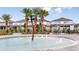 Community splash pad with palm tree feature and plenty of seating at 3560 Maple Bay Ln, Land O Lakes, FL 34638