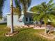 Cute light blue home with palm trees and a covered porch at 12501 Ulmerton Rd # 82, Largo, FL 33774