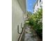 Exterior side view of the home and pathway lined with garden and foliage at 1943 Bayou Grande Ne Blvd, St Petersburg, FL 33703