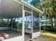 Spacious screened patio with a waterfront view, perfect for outdoor living and enjoying the tropical scenery at 1943 Bayou Grande Ne Blvd, St Petersburg, FL 33703
