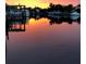 Picturesque waterfront with boats docked at sunset, reflecting a serene and luxurious coastal living experience at 1943 Bayou Grande Ne Blvd, St Petersburg, FL 33703