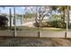 Screened lanai view of backyard leading to a waterfront with private dock in a tropical setting at 1943 Bayou Grande Ne Blvd, St Petersburg, FL 33703