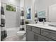 Bathroom featuring a tub-shower combination, ample lighting, and modern fixtures at 26810 Weiskopf Dr, Englewood, FL 34223