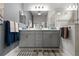 Bathroom with double sinks, modern fixtures, ample storage and bright lighting at 26810 Weiskopf Dr, Englewood, FL 34223