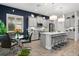 Bright, modern kitchen with gray cabinets, stainless steel appliances, quartz counters and a large island at 26810 Weiskopf Dr, Englewood, FL 34223