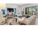 Comfortable living room with a large sectional sofa, stylish decor, and access to outdoor patio at 26810 Weiskopf Dr, Englewood, FL 34223