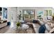 Comfortable living room with a large sectional sofa, stylish decor, and access to outdoor patio at 26810 Weiskopf Dr, Englewood, FL 34223