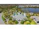 Aerial view of a community pool with multiple pools, palm trees, seating, and beautiful landscaping at 26810 Weiskopf Dr, Englewood, FL 34223