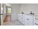 Bright bathroom featuring a dual sink vanity, white marble floor and black hardware at 407 S Albany Ave # 2, Tampa, FL 33606
