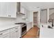 Close up of the kitchen with gas stove and door to the pantry at 407 S Albany Ave # 2, Tampa, FL 33606