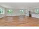 Bright, open-concept living room featuring large windows, recessed lighting, and light, natural wood floors at 407 S Albany Ave # 2, Tampa, FL 33606