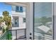 Balcony view of the white siding of the home with green trimmed windows at 407 S Albany Ave # 6, Tampa, FL 33606