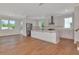 Modern kitchen with white cabinets, stainless steel appliances, island and hardwood floors in an open floorplan at 407 S Albany Ave # 6, Tampa, FL 33606