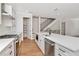 Modern kitchen featuring a walk-in pantry, stainless steel appliances, and a staircase in the background at 407 S Albany Ave # 6, Tampa, FL 33606