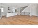 Spacious living room featuring a modern kitchen, hardwood floors, and staircase with black metal railing at 407 S Albany Ave # 6, Tampa, FL 33606