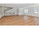 Bright living room with hardwood floors, staircase with black metal railing, and natural light from several windows at 407 S Albany Ave # 6, Tampa, FL 33606