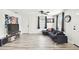 Bright living room with dark gray sectional sofa and wood-look flooring at 7125 Colfax Dr, Port Richey, FL 34668