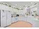 Bright white kitchen with an island, plenty of counter space and cabinets at 5195 Highbury Cir, Sarasota, FL 34238
