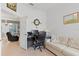 Bright home office features built-in desk, comfortable seating, and views to the living room at 5195 Highbury Cir, Sarasota, FL 34238