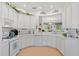 White kitchen with a large island and peninsula, offering plenty of counter and cabinet space at 5195 Highbury Cir, Sarasota, FL 34238