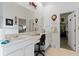 Main bathroom with double vanity, walk-in closet access, and additional storage at 5195 Highbury Cir, Sarasota, FL 34238