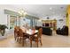Elegant dining room with a large wooden table, and access to the living room at 5195 Highbury Cir, Sarasota, FL 34238
