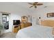 Cozy bedroom with a queen-size bed, dresser, and private access to a screened patio at 5195 Highbury Cir, Sarasota, FL 34238