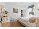 Second bedroom with a full-size bed, dresser, and a window overlooking the backyard at 5195 Highbury Cir, Sarasota, FL 34238