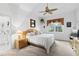 Spacious main bedroom with a king-size bed, ceiling fan, and en-suite bathroom access at 5195 Highbury Cir, Sarasota, FL 34238