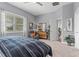 Serene bedroom with gray walls, a comfortable bed, and access to a hallway at 26810 Weiskopf Dr, Englewood, FL 34223