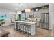 Modern kitchen with gray cabinets and a large island at 26810 Weiskopf Dr, Englewood, FL 34223