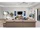 Living room with sectional sofa and large flat-screen TV at 26810 Weiskopf Dr, Englewood, FL 34223