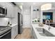 Modern kitchen features stainless steel appliances and gray cabinets at 26810 Weiskopf Dr, Englewood, FL 34223