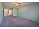 Large bedroom with grey carpet and ceiling fan at 1148 Emerald Hill Way, Valrico, FL 33594