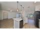 Updated kitchen featuring white cabinets, quartz countertops and island at 1148 Emerald Hill Way, Valrico, FL 33594