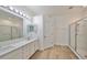Bathroom with double vanity, quartz countertop, and walk-in shower at 1148 Emerald Hill Way, Valrico, FL 33594