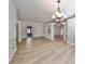 Open dining area with hardwood floors and chandelier at 1148 Emerald Hill Way, Valrico, FL 33594