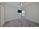 Bedroom with TV mount, ceiling fan and grey carpet at 1148 Emerald Hill Way, Valrico, FL 33594