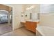 Bathroom with vanity, bathtub, and view of bedroom at 6419 43Rd E Ct, Sarasota, FL 34243