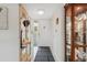 Bright condo entryway with mirror, cabinet, and tiled floor at 3942 Trophy Blvd, New Port Richey, FL 34655