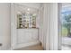 Built-in wet bar with glass shelving and mirrored backsplash at 3942 Trophy Blvd, New Port Richey, FL 34655