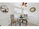 Charming breakfast nook with glass table and two chairs, located near the kitchen at 3942 Trophy Blvd, New Port Richey, FL 34655